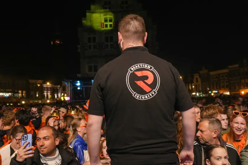 Beveiliger van Reaction Security houdt overzicht bij een druk bezocht avondevenement